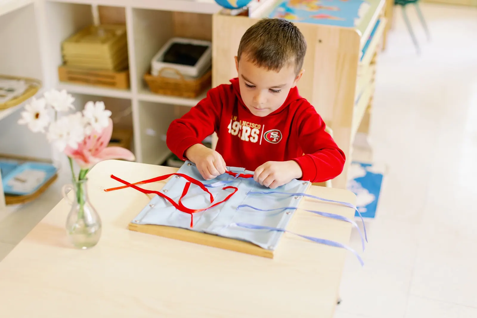 Primary student working with Montessori materials